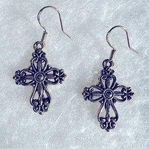 Silver tone cross earrings.